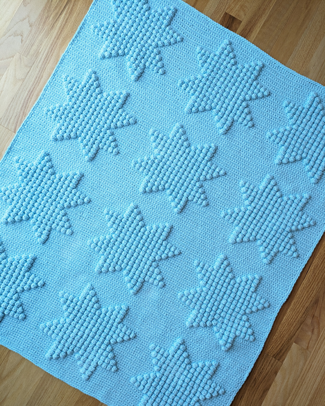 light blue blanket with eight point star motifs